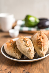 Hot pies with mushrooms on plate, vegetable calzone