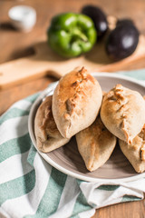 Hot pies with mushrooms on plate, vegetable calzone