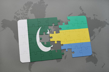 puzzle with the national flag of pakistan and gabon on a world map background.