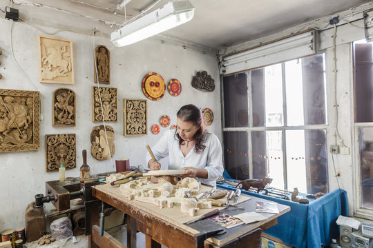 Woodcarving artisan in whittling workshop