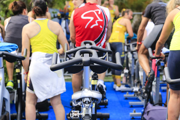 People preparing to perform a spinning session outdoors