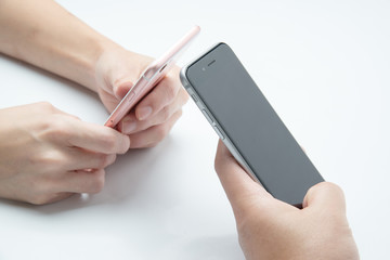close up of hands of couple using smart phone