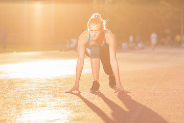 young girl teenager sprinter start position