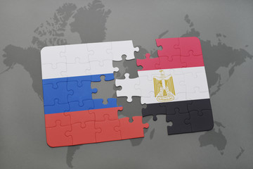 puzzle with the national flag of russia and egypt on a world map background.