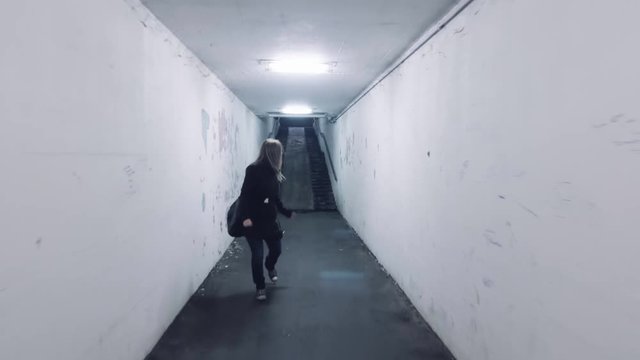 frightened scared woman in panic running away from murdered rapist bad man shaky effect front view horror dark mood