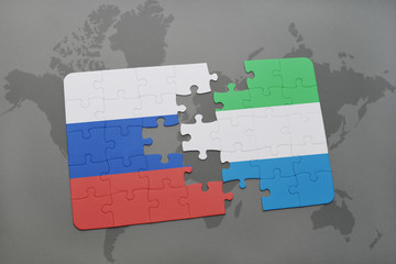 puzzle with the national flag of russia and sierra leone on a world map background.