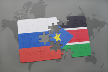 puzzle with the national flag of russia and south sudan on a world map background.
