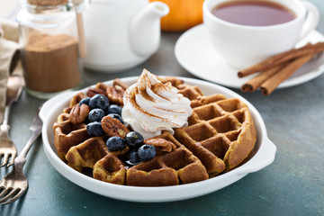 Pumpkin waffles with whipped cream for breakfast