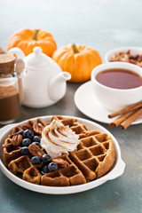 Pumpkin waffles with whipped cream for breakfast