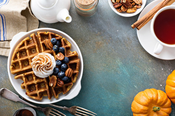 Pumpkin waffles with whipped cream for breakfast