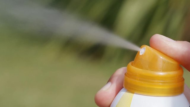 Aerosol spray for sun protection being released, in slow motion