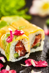 Maki Sushi - Roll made of Salmon, Cream Cheese and Cucumber inside, Avocado and Cheese outside