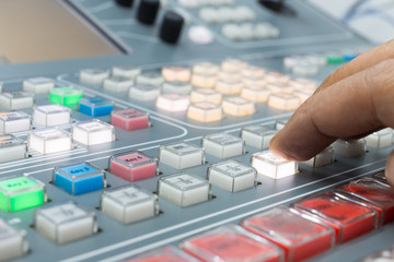 Hands of a cinematographer who worked on the vision mixer, switch the TV panel to the gallery.