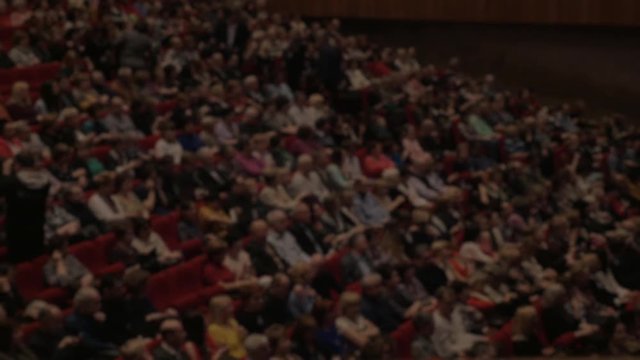 A lot of people applaud in the movie theater. Cinema and entertainment