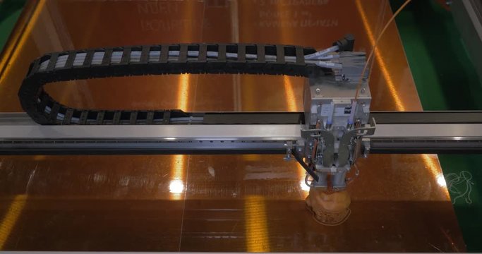 In ECC Sokolniki, Moscow at exhibition of 3D Expo seen mechanism of 3D printer working on printing plastic toys. Printing technology