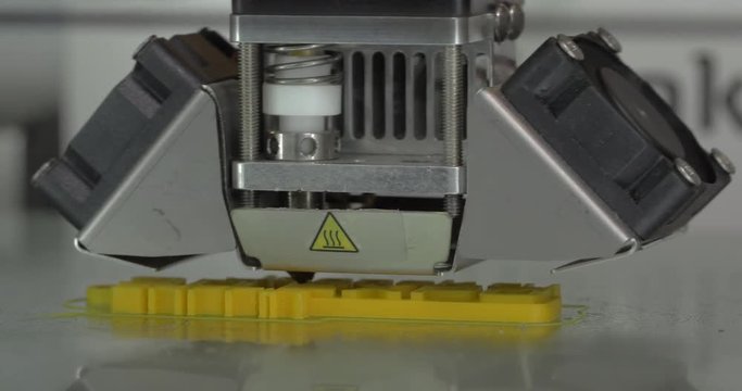 In ECC Sokolniki, Moscow at exhibition of 3D Expo seen mechanism of 3D printer working on printing object. Printing technology