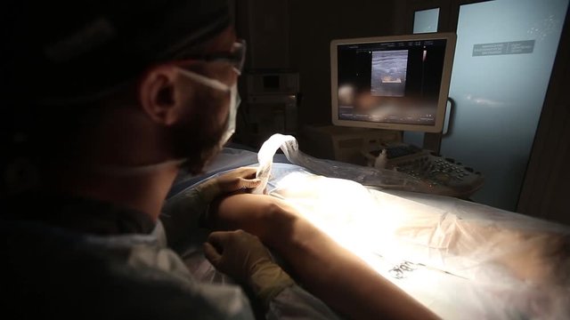 Doctor looking at modern ultrasound device