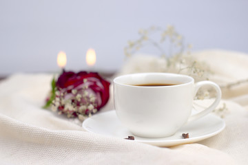 coffee in bed. cup of coffee with spices cloves on a white blanket