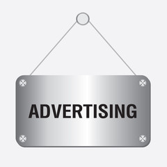 silver metallic advertising sign hanging on the wall 