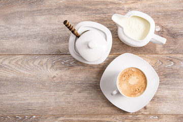 Coffee with milk and sugar on wood table top view 