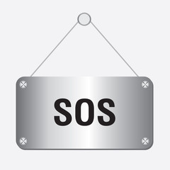 silver metallic SOS sign hanging on the wall