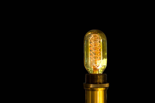 Tungsten light bulb glowing in isolated