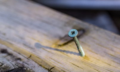 Screw on old wooden desk.
