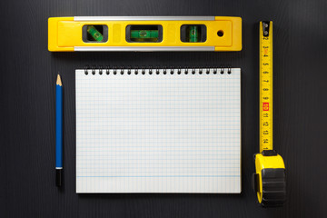 notebook and pencil on wood