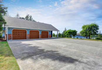 Three garages with blue and brick trim.