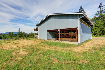 Fototapeta na wymiar Blue big barn at the backyard