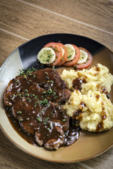 beef steak meal with mashed potato and gravy sauce