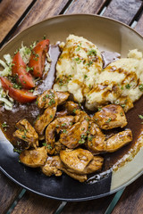 chicken breast with brown gravy sauce and mashed potato