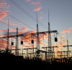 distribution electric substation pylon with lines, at sunset.