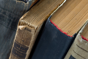Different vintage, antiquarian, tattered books close up