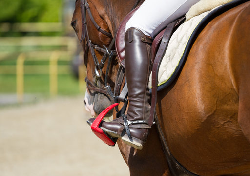 Jockey riding boot in the stirrup
