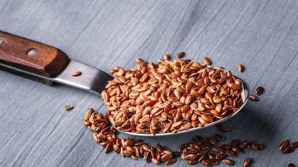 Flax seeds linseed on kitchen spoon