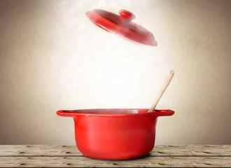 Schilderijen op glas Big red pot for soup with spoon and fork © Zarya Maxim