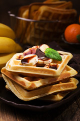 Delicious waffles with banana and chocolate