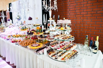 Elegance wedding reception table with food and decor.