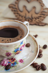 Vintage cup of coffee and coffee beans on the table