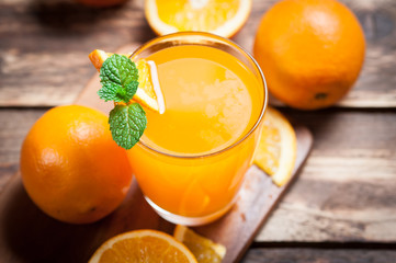 Fresh fruits Orange juice in glass on wood,Selective focus on gl