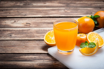 Fresh fruits Orange juice in glass on wood,Selective focus on gl