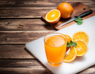 Fresh fruits Orange juice in glass on wood,Selective focus on gl