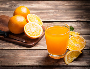 Fresh fruits Orange juice in glass on wood,Selective focus on gl