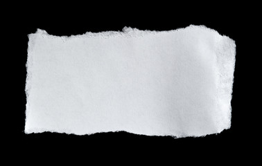 White torn of paper isolated on a black background.