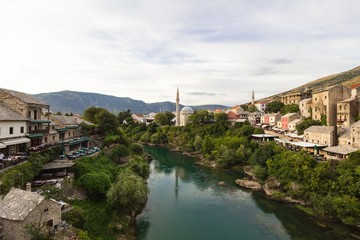 Fototapeta na wymiar Evening scene in Mostar with the medieval town, the Neretva river in Bosnia Herzegovina