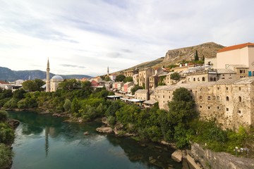 Fototapeta na wymiar Afternoon scene in Mostar with the medieval town, the Neretva river in Bosnia Herzegovina