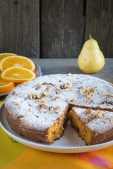 Delicious carrot cake with nuts and raisins on a white plate.