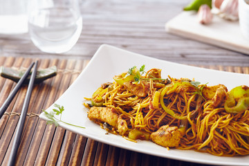 sweet chili noodles in a white serving plate with chopsticks, bright colors, modern style