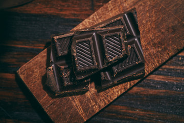 dark chocolate tabs on a small chopping board on a wooden table